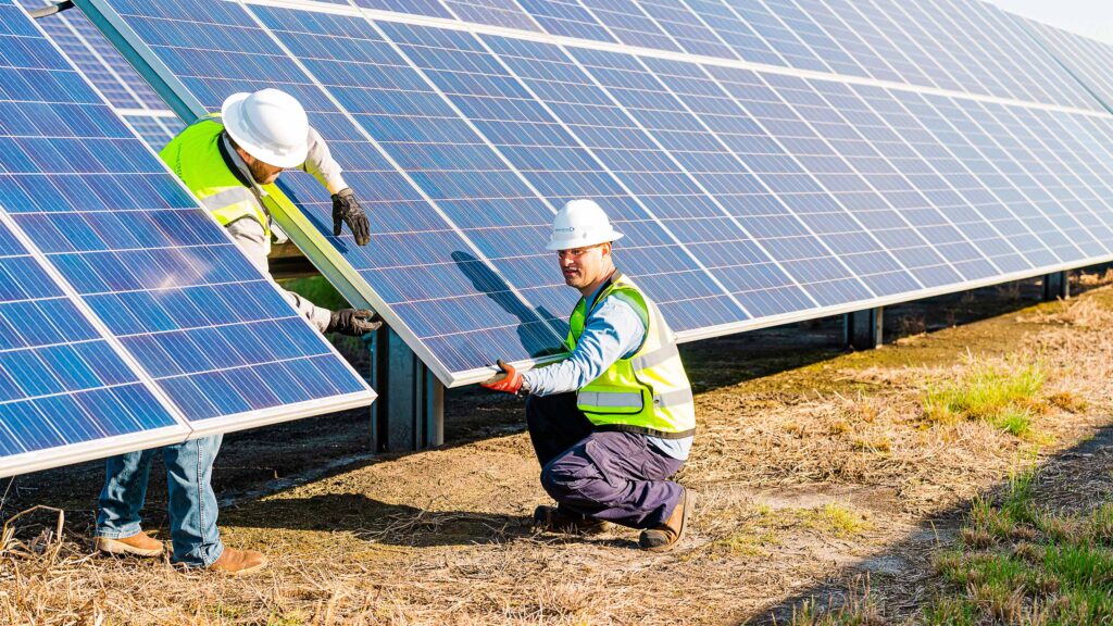 Engineers constructing a solar array on a solar farm.