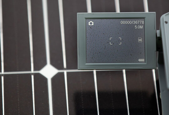 A microscope shows soiling on a solar panel